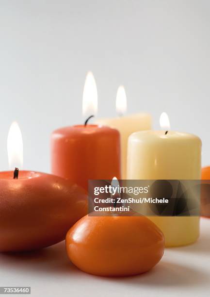 lit candles - candle sets foto e immagini stock