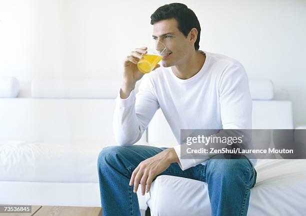 man drinking juice - leaning on elbows stock pictures, royalty-free photos & images