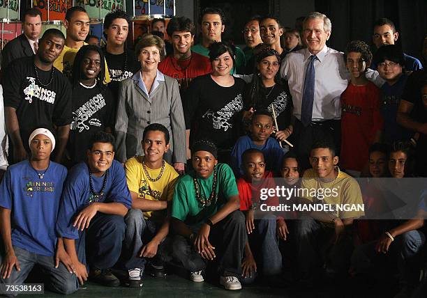 President George W. Bush and First Lady Laura Bush poses with dancers and muscians after their performance at the ?Meninos do Murumbi? 09 March 2007...