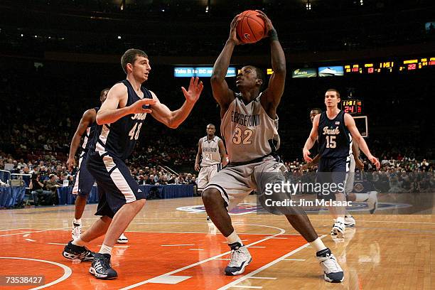 Luke Zeller of the Notre Dame Fighting Irish defends Jeff Green of the Georgetown Hoyas during the semifinals of the Big East Championship at Madison...