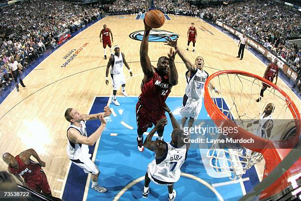 Shaquille O'Neal of the Miami Heat shoots against Devin Harris and DeSagana Diop of the Dallas Mavericks during the game at the American Airlines...