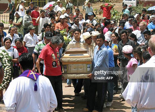 Relatives of Rufina Amaya, the only survivor of a massacre of more than one thousand farmers during the last civil war in El Salvador, carry her...