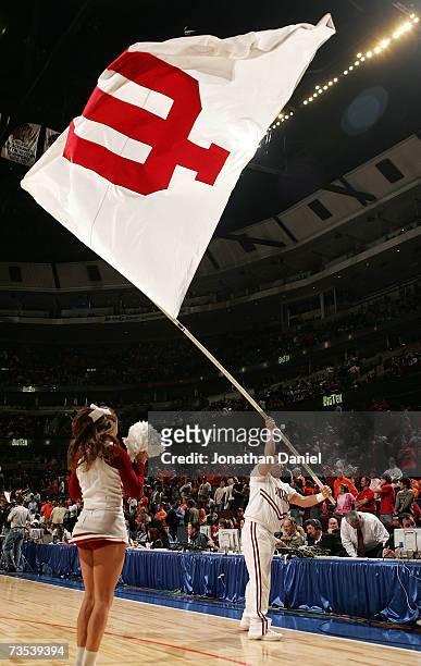 Cheerleader from the Indiana Hoosiers waves a flag on the court during warm-ups against the Illinois Fighting Illini during the quarterfinals of the...