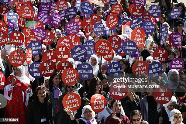 Turkish Kurd women hold placards, reading: "Viva 8 March," during the last International Women's Day in the southeastern Turkish city of Diyarbakir...