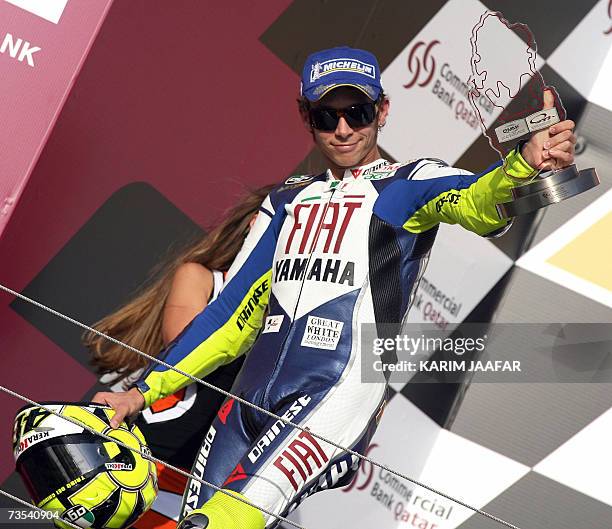 Italian rider and seven-time world champion Valentino Rossi celebrates his second place finish at the Qatar Grand Prix in Doha, 10 March 2007....