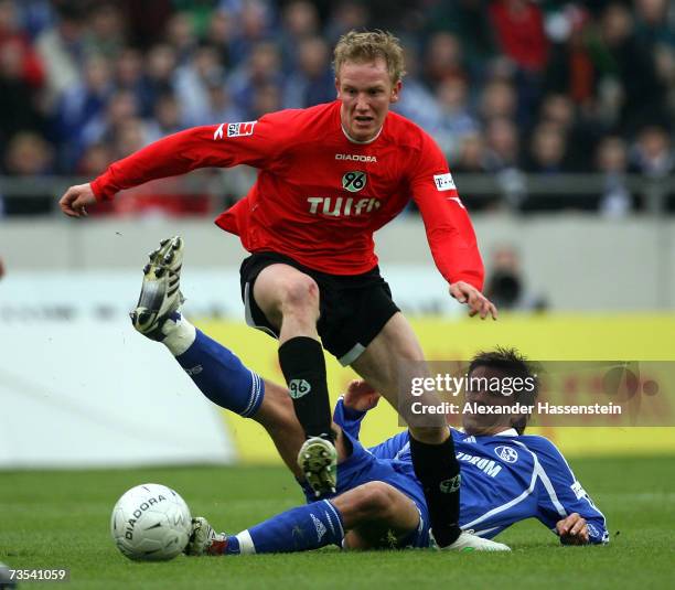 Jan Rosenthal of Hanover challenge for the ball with Zlatan Bajramovic of Schalke during the Bundesliga match between Hanover 96 and Schalke 04 at...