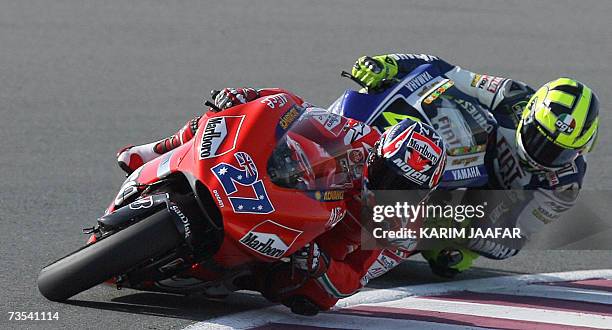 Australian rider Casey Stoner leads Italian rider and seven-time world champion Valentino Rossi at the Qatar Grand Prix in Doha, 10 March 2007....