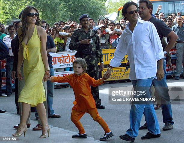 Indian businessman Arun Nayar walks with his wife Elizabeth Hurley and her son Damian as they arrive at Jodhpur Airport, 10 March 2007, before...