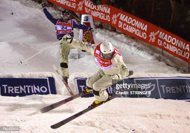 Australian Dale Begg-Smith jumps in front of Tapio Luusua of Finland during the men's round 16 of Dual Moguls final of the Freestyle World...