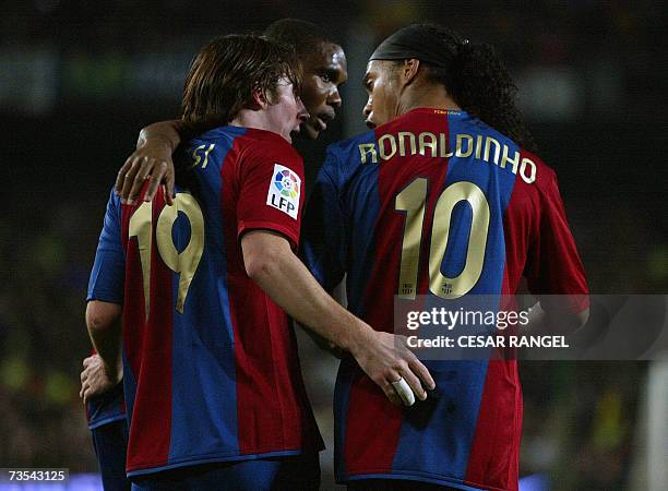 Barcelona's Leo Messi is congratulated by Ronaldinho and Samuel Eto'o after scoring his second goal against Real Madrid during a Spanish league...