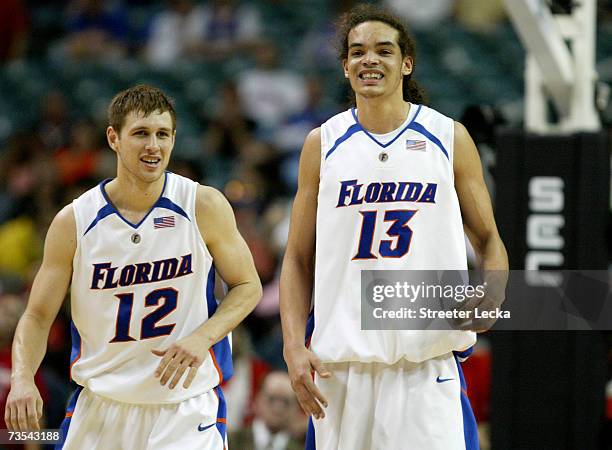 Joakim Noah and teammate Lee Humphrey of the Florida Gators laugh after Noah shot an airball during their semifinal game victory over the Ole Miss...