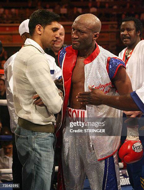 Liverpool, UNITED KINGDOM: French boxer Souleymane M'Baye is congratulated by British boxer Amir Khan after retaining his WBA Light Welterweight...