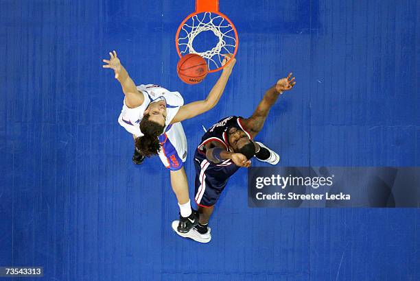 Kenny Williams of the Ole Miss Rebels fights for a rebound with Joakim Noah of the Florida Gators during their semifinal game in the Southeastern...