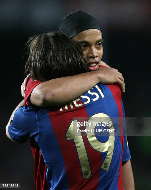Barcelona's Argentinian Leo Messi celebrates with Brazilian Ronaldinho after scoring his third goal against Real Madrid during a Spanish league...