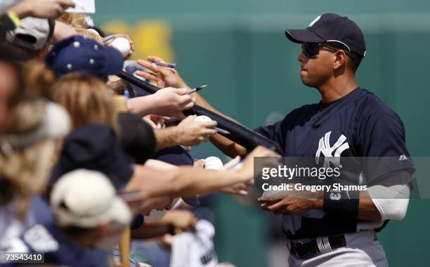 Alex Rodriguez of the New York Yankees takes time to sign autographs for fans prior to a Spring Training game against the Pittsburgh Pirates on March...