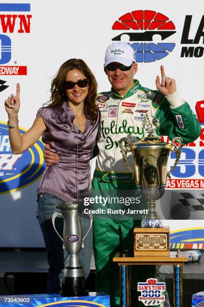 Jeff Burton, driver of the Holiday Inn Chevrolet , stands with his wife Kim, in victory lane, following the NASCAR Busch Series Sam's Town 300 at Las...