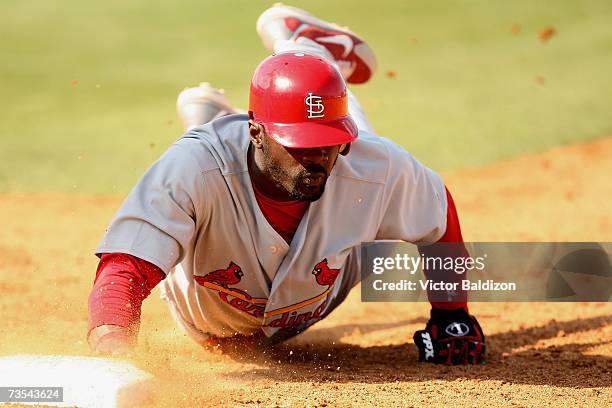 Preston Wilson of the St.Louis Cardinals slides back to first base against the Baltimore Orioles during a Spring Training game at the Fort Lauderdale...