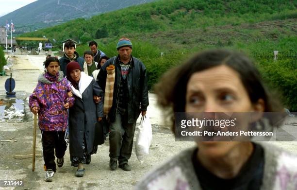 Ethnic Albanian refugees from Kosovo arrive at Morina borderpost April 4, 1999 outside Kukes, Albania. Tens of thousands of people fled the fighting...