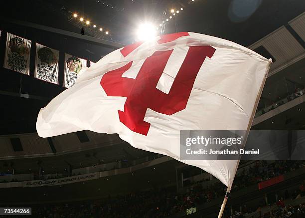 Cheerleader from the Indiana Hoosiers waves a flag with Indiana's logo on the court against the Illinois Fighting Illini during the quarterfinals of...