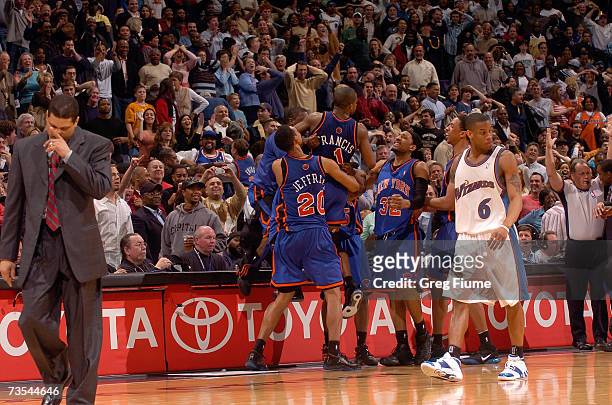 Steve Francis of the New York Knicks is surrounded by Jared Jeffries and Renaldo Balkman after hitting the game winning three-point shot against the...