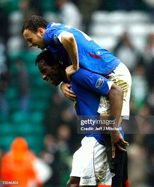 Alan Hutton jumps on Ugo Ehiogu of Rangers at the end of the Scottish Premier League match between Celtic and Rangers at Celtic Park on March 11 2007...