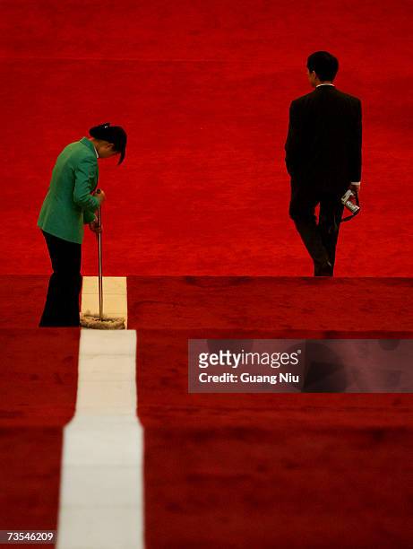 Delegate walks past an attendant during the third plenary session of the National People's Congress, or parliament, at the Great Hall of the People...