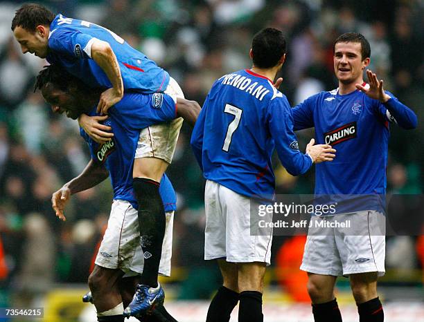 Alan Hutton jumps on Ugo Ehiogu of Rangers at the end of the Scottish Premier League match between Celtic and Rangers at Celtic Park on March 11 2007...