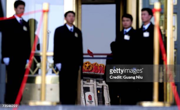 Plainclothes soldiers guard an entrance of the Great Hall of the People ahead the third plenary session of the National People's Congress, or...