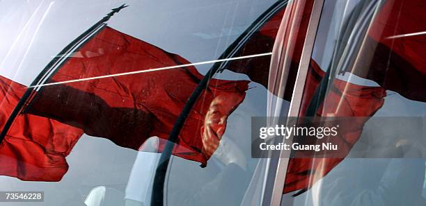 Delegates look out from a bus after attendeding the third plenary session of the National People's Congress, or parliament, at the Great Hall of the...