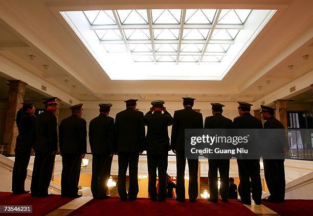 Military delegates prepare for a photo during the third plenary session of the National People's Congress, or parliament, at the Great Hall of the...