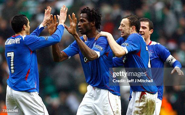 Alan Hutton and Barhim Hemdani congratulate Ugo Ehiogu of Rangers at the end of the Scottish Premier League match between Celtic and Rangers at...