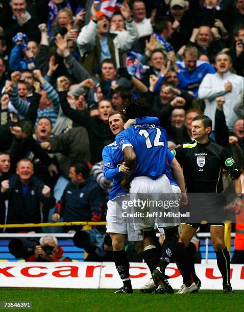 Barry Ferguson congratulates Ugo Ehiogu of Rangers after scoring during the Scottish Premier League match between Celtic and Rangers at Celtic Park...
