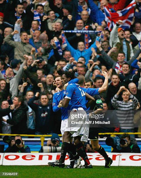 Barry Ferguson congratulates Ugo Ehiogu of Rangers after scoring during the Scottish Premier League match between Celtic and Rangers at Celtic Park...