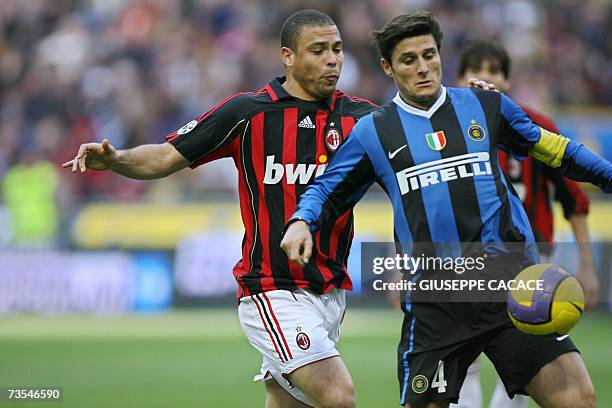 Inter's defender Javier Zanetti of Argentina challenges for the ball with AC Milan's forward Ronaldo of Brazil during their Serie A match at San Siro...