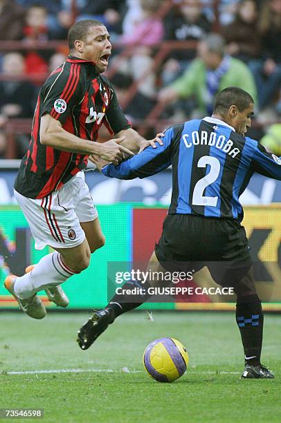Inter's defender Ivan Cordoba of Colombia challenges for the ball with AC Milan's forward Ronaldo of Brazil during their Serie A football match at...