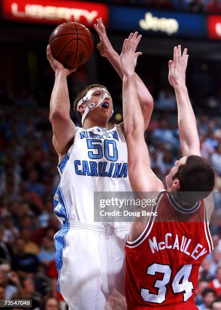 Tyler Hansbrough of the North Carolina Tar Heels shoots over Ben McCauley of the North Carolina State Wolfpack in the ACC Men's Basketball Tournament...