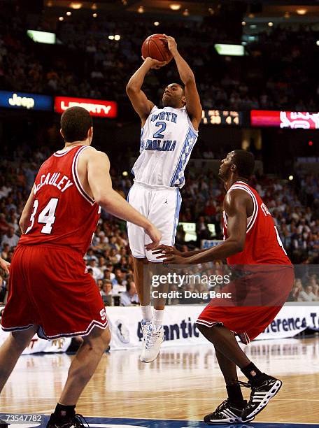 Wayne Ellington of the North Carolina Tar Heels shoots a jump shot over Ben McCauley and Courtney Fells of the North Carolina State Wolfpack in the...