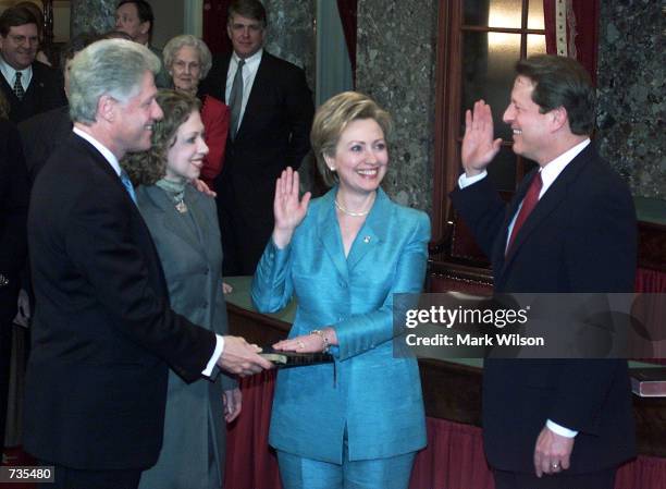 Vice President Al Gore swears in new U.S. Senator Hillary Clinton January 3, 2001 while her husband President Bill Clinton and daughter Chelsea look...