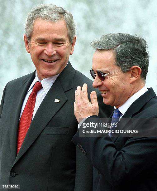 Colombian President Alvaro Uribe shares a joke with US President George W. Bush 11 March, 2007 during a welcome ceremony at the Palacio Narino...