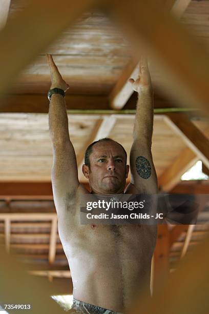 Tom Carroll from Newport Beach, Australia practices yoga at Bobby's G-Land Surf Camp June 22, 2006 in Grajagan, Indonesia.