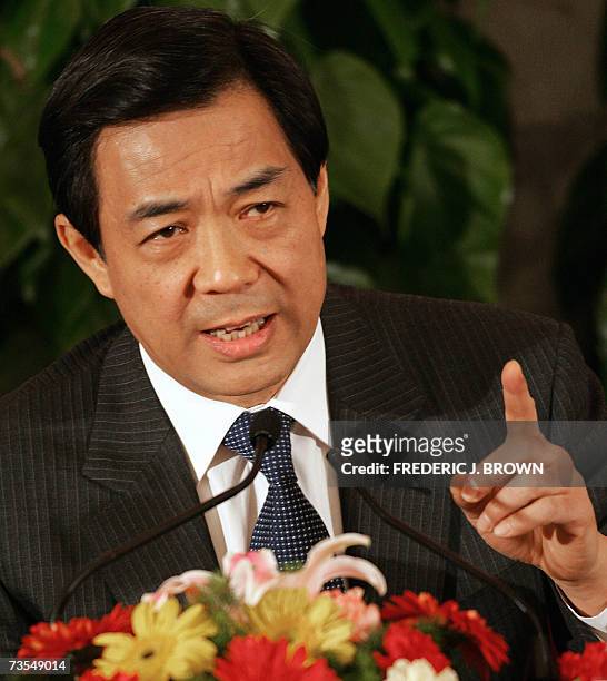 Commerce Minister Bo Xilai gestures during a press conference with central bank governor Zhou Xiaochuan on the sidelines of China's ongoing annual...