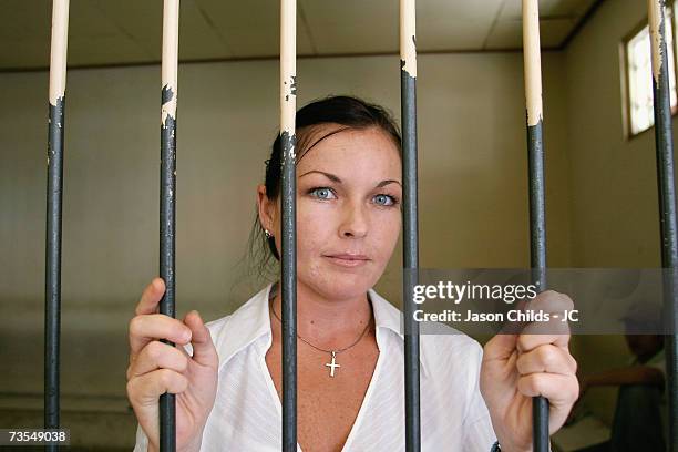 Schappelle Corby stands behind the bars in the holding cell at Denpasar District Court August 25, 2006 in Denpasar, Bali, Indonesia. Corby's defence...