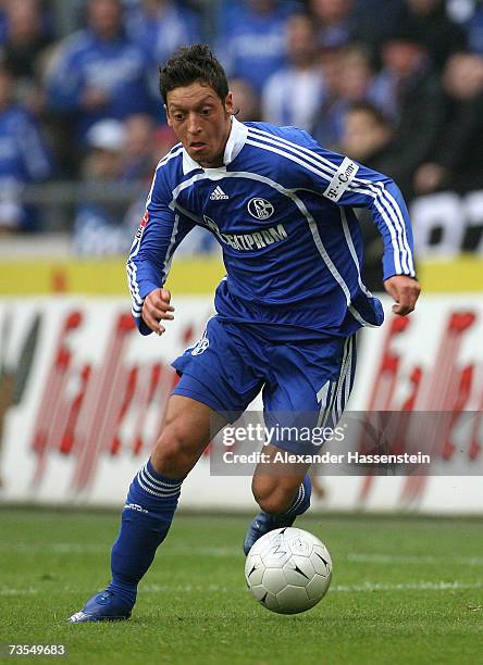 Mesut Oezil of Schalke runs with the ball during the Bundesliga match between Hanover 96 and Schalke 04 at the AWD Arena on March 10, 2007 in...