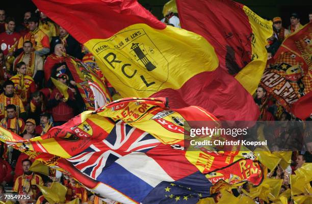 The fans of Lens wave the flags during the UEFA Cup round of sixteen, first leg match between RC Lens and Bayer Leverkusen at the Stade...