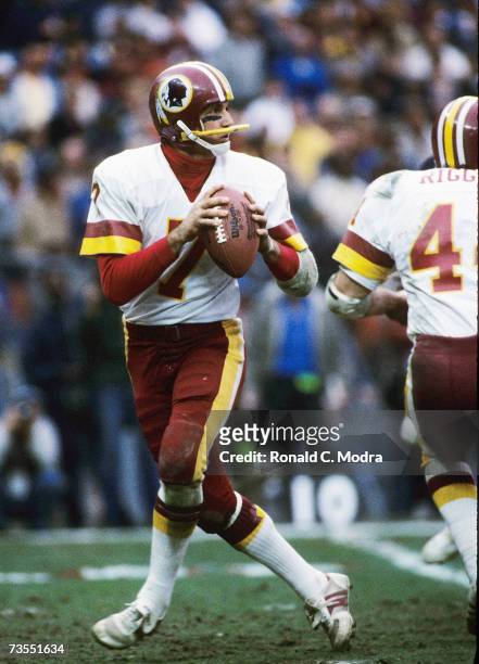 Quarterback Joe Theisman of the Washington Redskins goes back to pass in the NFC Divisional Playoff Game against the Chicago Bears on December 30,...