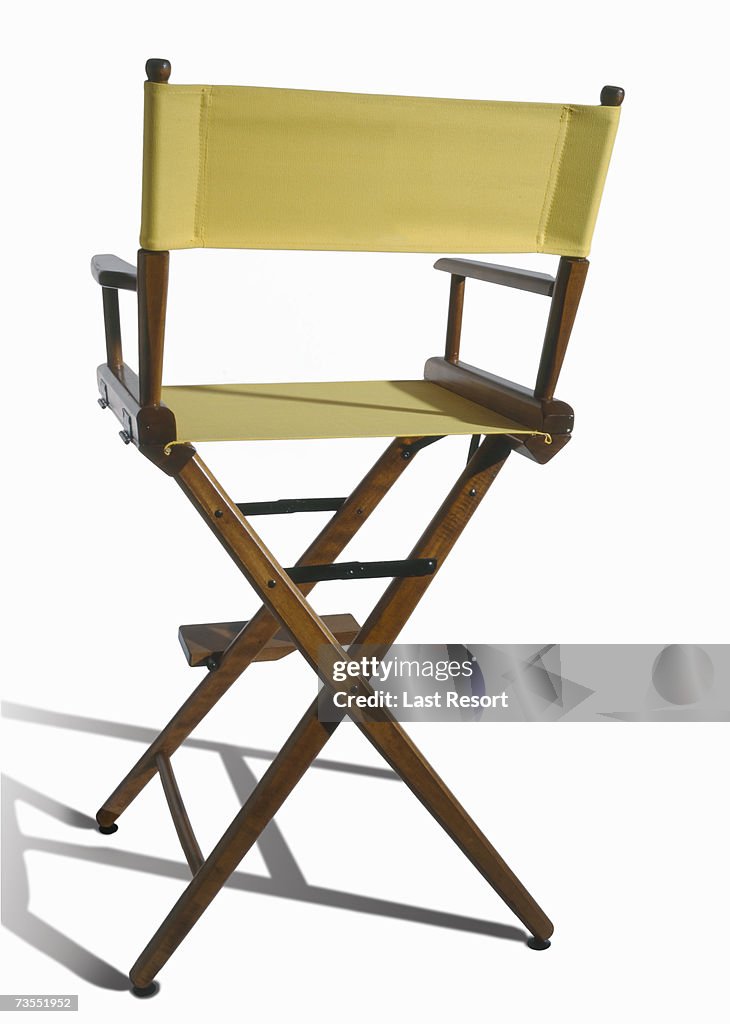 Vacant yellow directors chair on white background