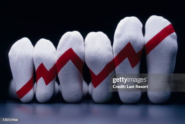 graph drawn on soles of row of socks - change socks stockfoto's en -beelden