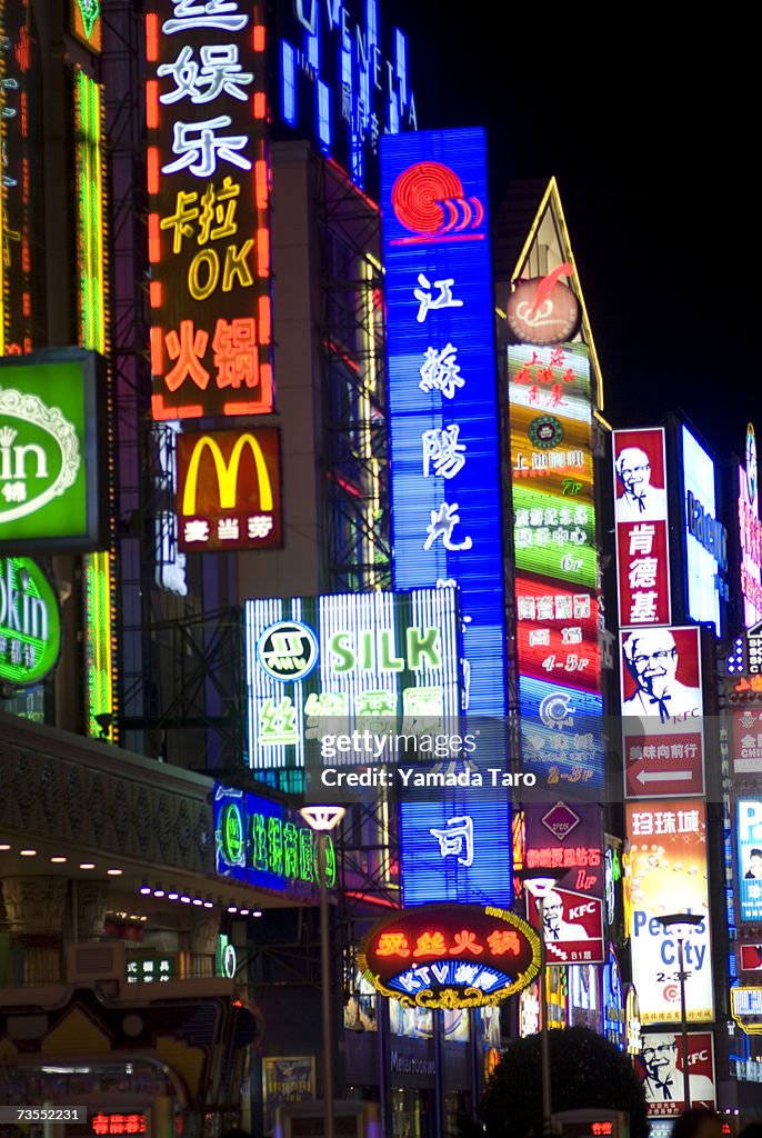 China, Shanghai, neon signs on building at night