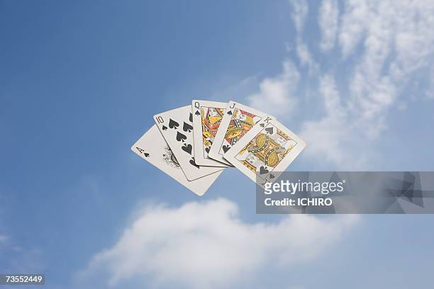 royal flush of cards against cloudy sky - royal flush stockfoto's en -beelden