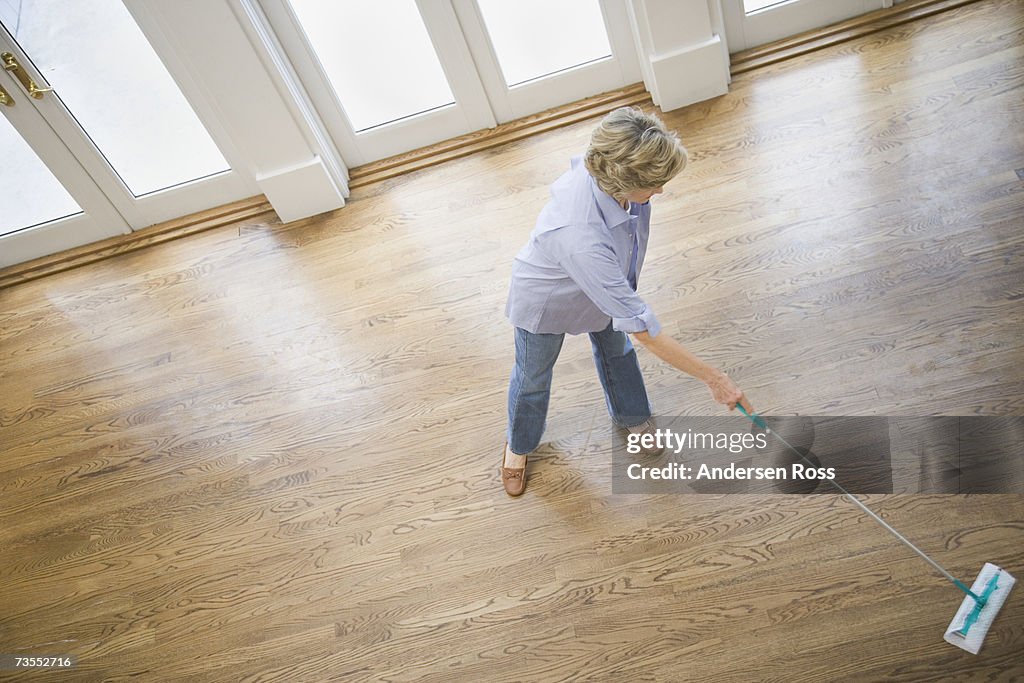 Senior woman cleaning floor, elevated view